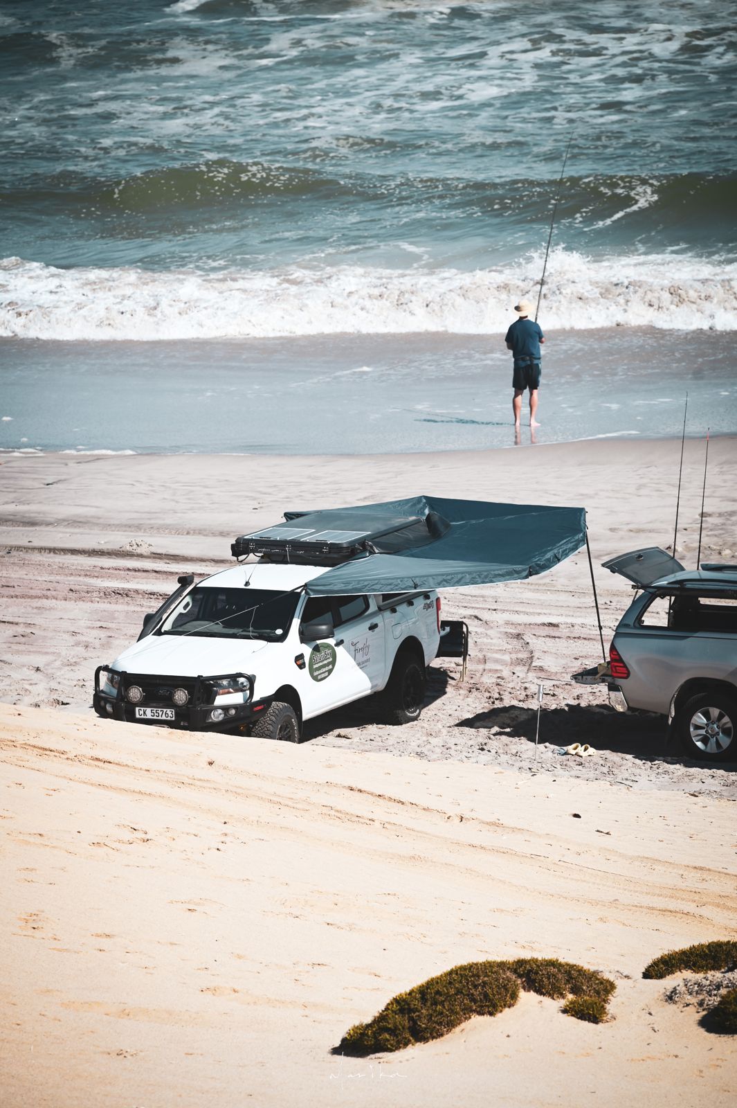 Beach camp with rooftop tents and awnings on the West Coast
