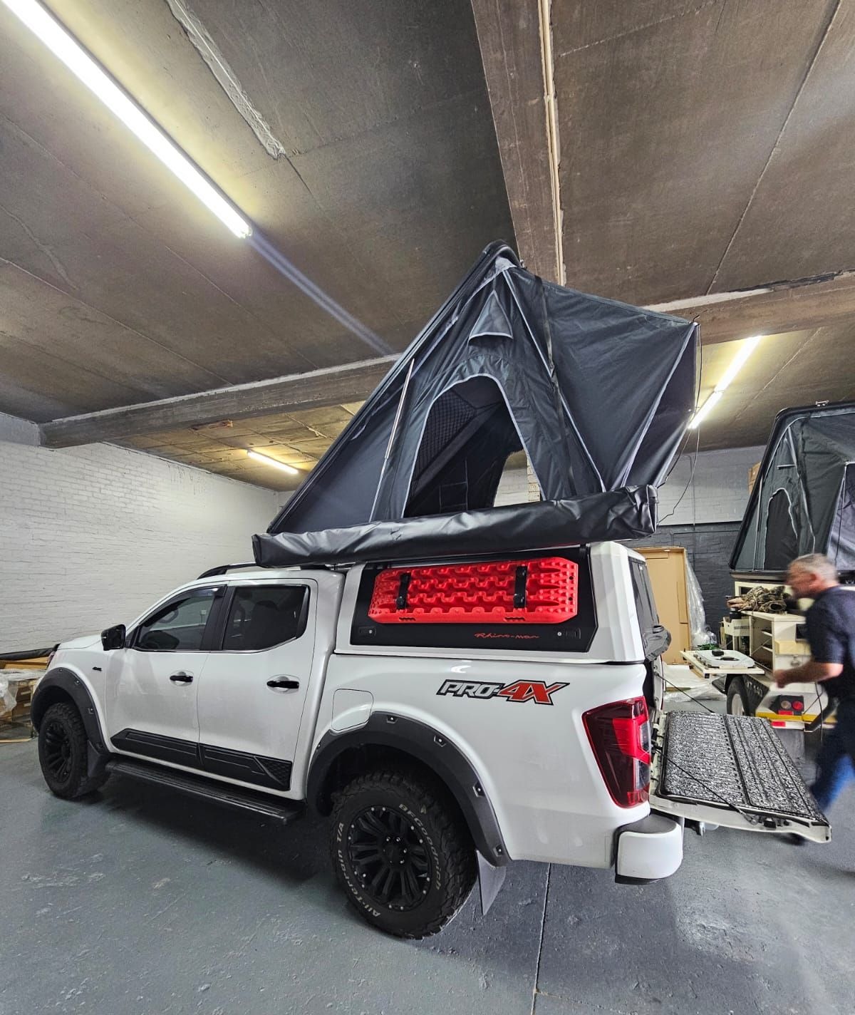 Safari Sky tent open on a white Nissan Navara PRO-4X in the fitment bay