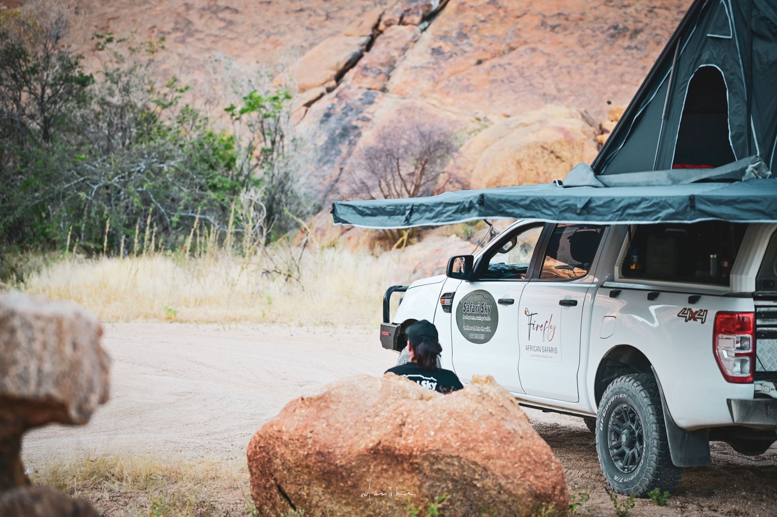 Ranger with rooftop tent and 180° awning parked among the rocks