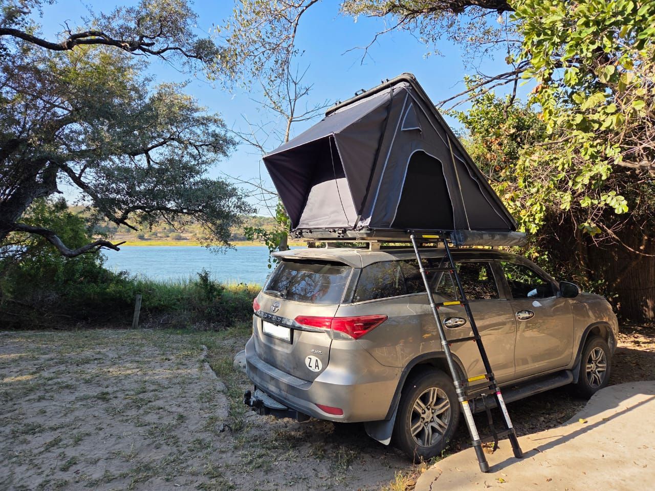 Toyota Fortuner with rooftop tent camped on the Kavango river bank