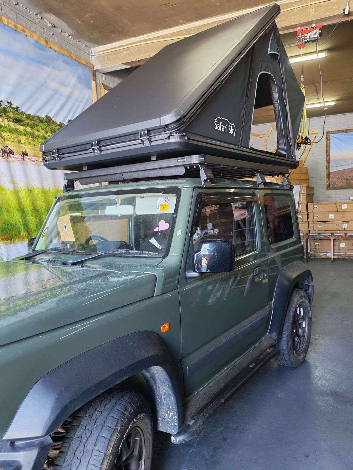 Safari Sky tent on a green Suzuki Jimny in the workshop